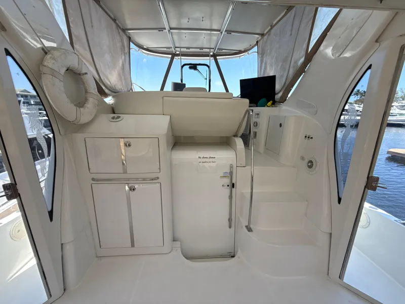Slide: The Image of 2001 Carver 396 Motor Yacht interior with helm, storage, and marina view. - 6