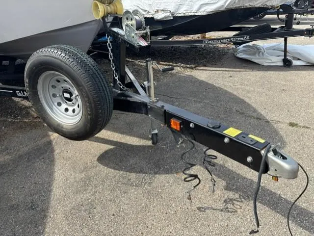 Slide: The Image of Trailer hitch of a 2021 Glastron GTS 185 boat on pavement. - 15