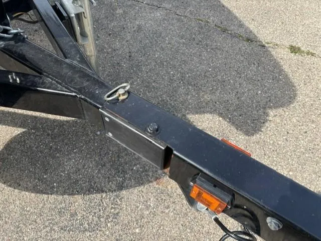 Slide: The Image of Trailer hitch of a 2021 Glastron GTS 185 boat on pavement. - 16