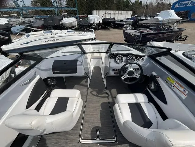 Slide: The Image of 2021 Glastron GTS 185 boat interior with white seating and modern dashboard. - 17