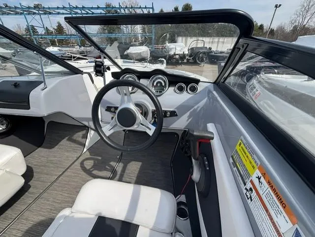 Slide: The Image of 2021 Glastron GTS 185 boat interior with steering wheel and dashboard controls. - 19
