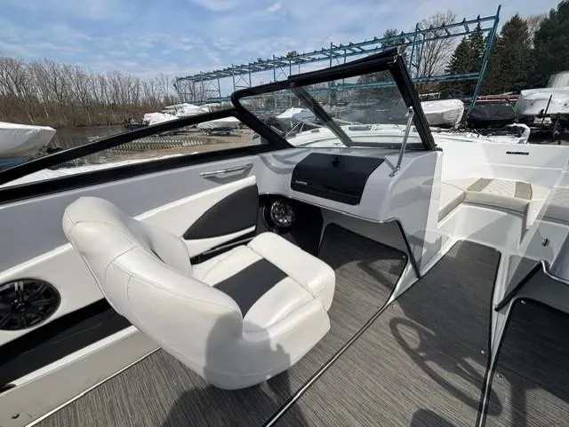 Slide: The Image of 2021 Glastron GTS 185 boat interior with white seating and modern dashboard. - 22