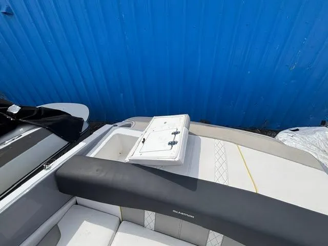 Slide: The Image of 2021 Glastron GTS 185 boat interior with open storage compartment, against blue background. - 27