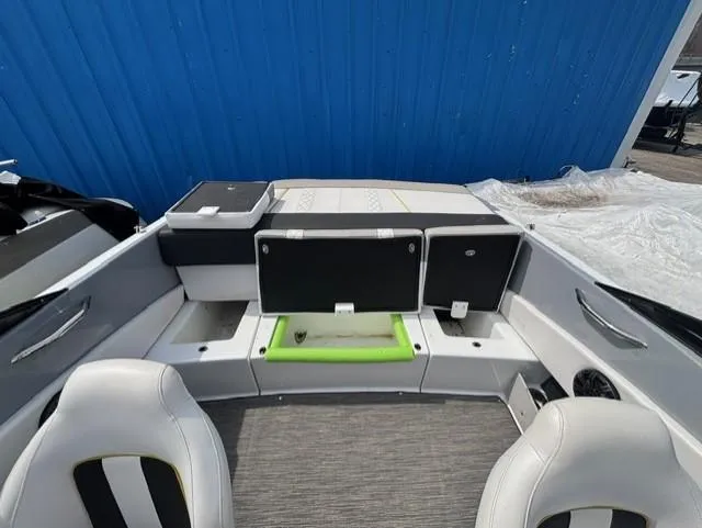 Slide: The Image of 2021 Glastron GTS 185 boat interior with seating and storage compartments. - 28