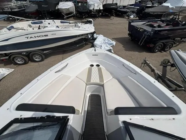 Slide: The Image of 2021 Glastron GTS 185 boat, top view, parked among other boats in a marina. - 29