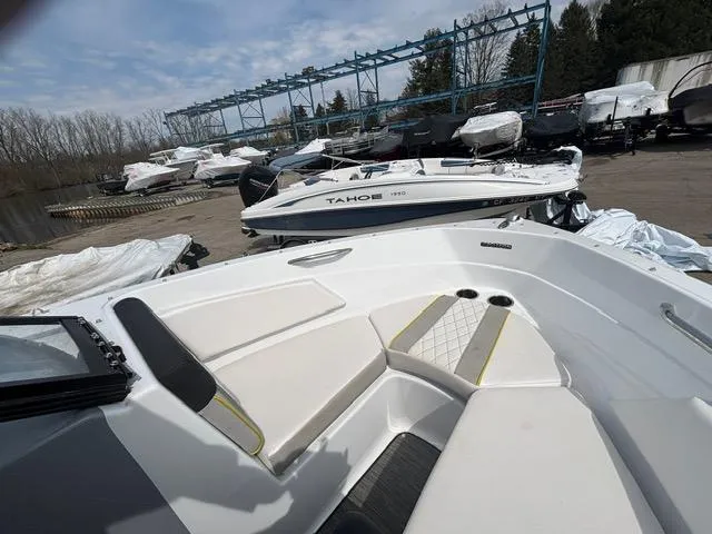 Slide: The Image of 2021 Glastron GTS 185 boat interior with docked vessels in background. - 30