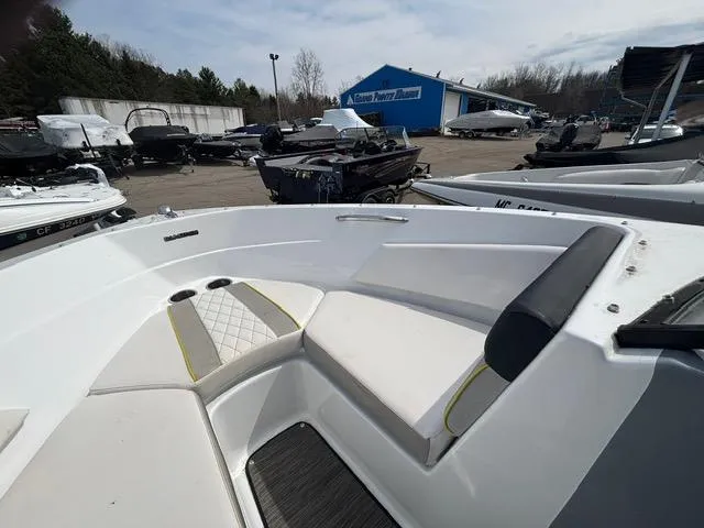 Slide: The Image of 2021 Glastron GTS 185 boat interior with seating, parked at a marina. - 31