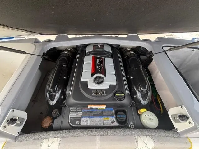 Slide: The Image of Engine compartment of a 2021 Glastron GTS 185 boat, featuring a powerful 4.5L engine. - 35