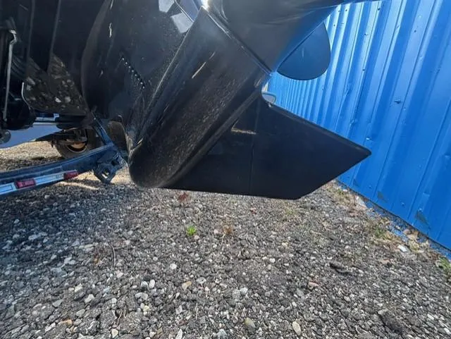 Slide: The Image of 2021 Glastron GTS 185 boat propeller and hull near blue wall. - 39