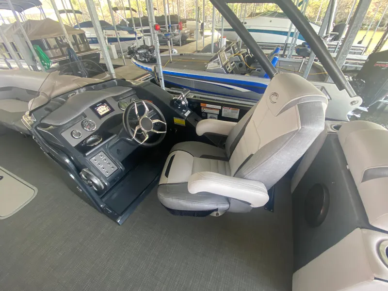 Slide: The Image of Captain's seat and helm of 2018 Crest Caliber 250 SLRC boat in marina. - 13