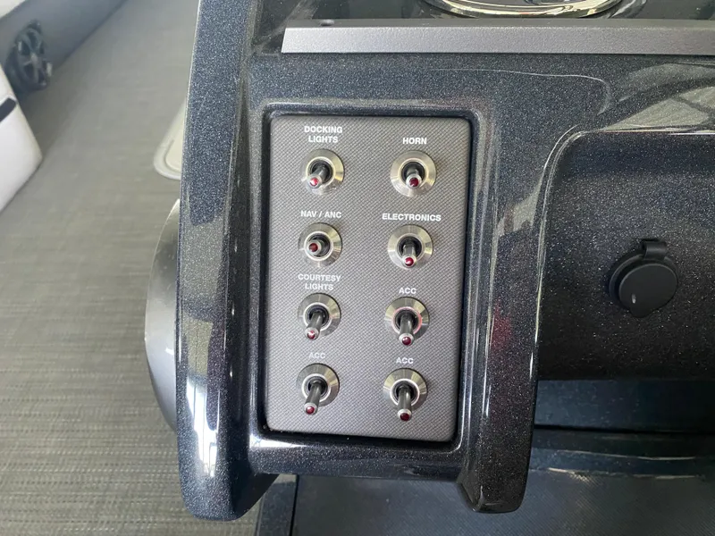 Slide: The Image of Control panel of a 2018 Crest Caliber 250 SLRC boat with various switches. - 17