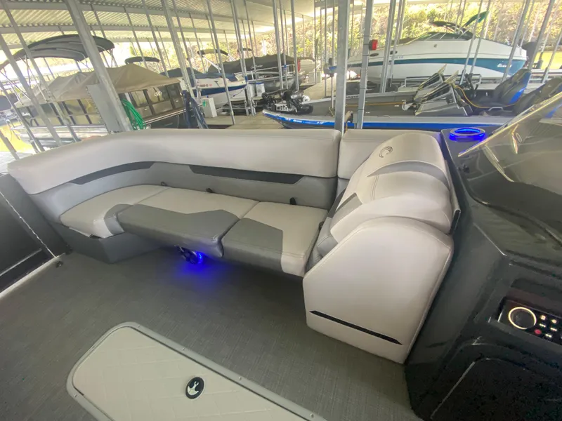 Slide: The Image of Luxurious 2018 Crest Caliber 250 SLRC boat interior with plush seating and ambient lighting. - 26