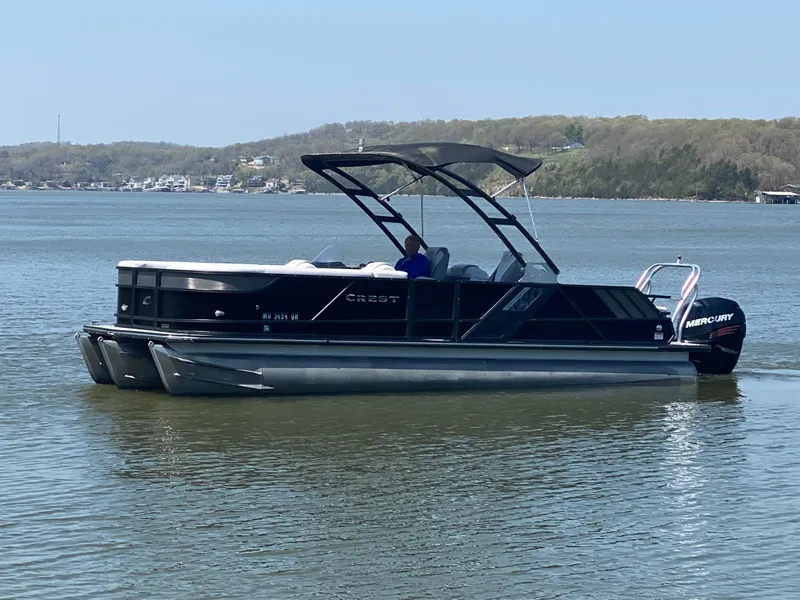 Slide: The Image of 2018 Crest Caliber 250 SLRC pontoon boat on a calm lake. - 3