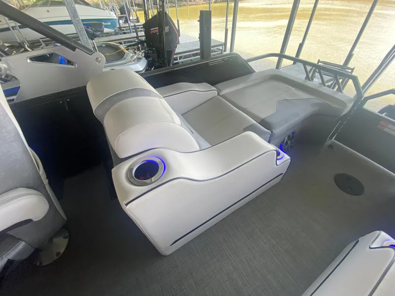 Slide: The Image of 2018 Crest Caliber 250 SLRC boat interior with plush seating and cup holders. - 31