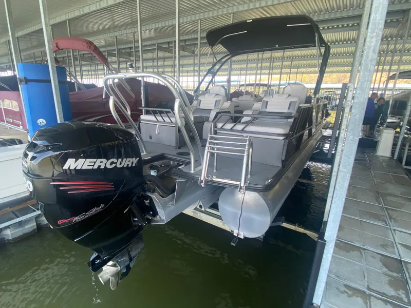 Slide: The Image of 2018 Crest Caliber 250 SLRC pontoon boat with Mercury engine in covered dock. - 6