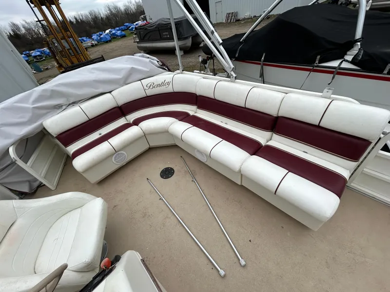 Slide: The Image of 2006 Bentley Pontoons 240 CRUISE with white and maroon seating, outdoor storage setting. - 11