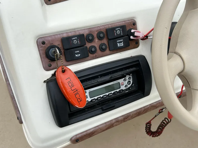 Slide: The Image of Control panel of a 2006 Bentley Pontoons 240 CRUISE with radio and switches. - 14