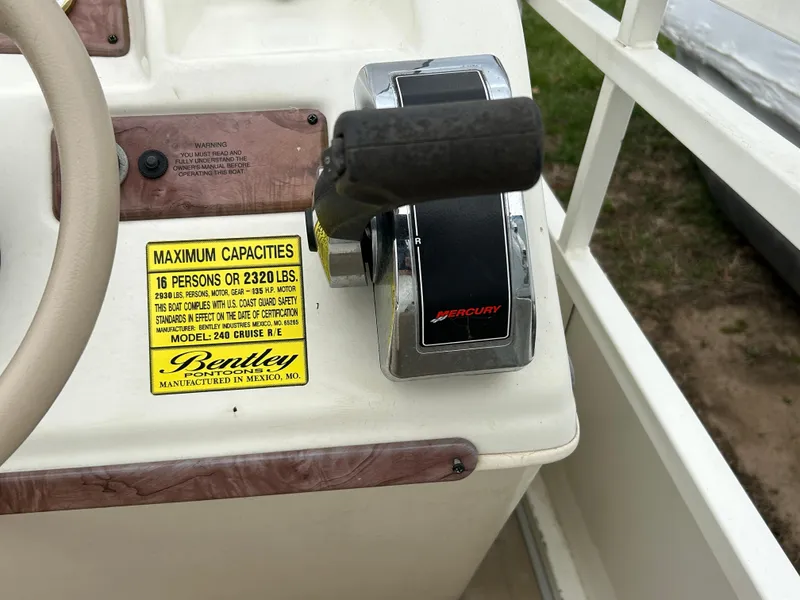 Slide: The Image of 2006 Bentley Pontoons 240 CRUISE control panel with capacity label and throttle lever. - 15