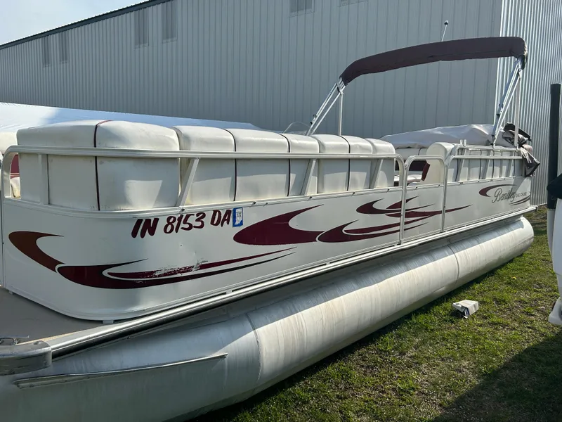 Slide: The Image of 2006 Bentley Pontoons 240 CRUISE boat with maroon accents, docked on grass. - 4