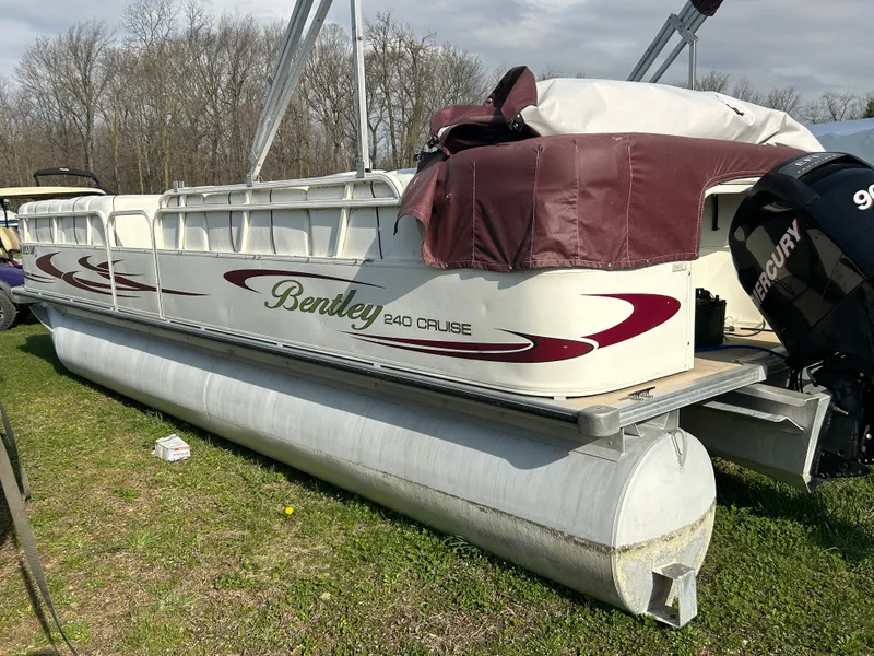 Slide: The Image of 2006 Bentley Pontoons 240 CRUISE boat on grass, featuring Mercury outboard motor. - 5