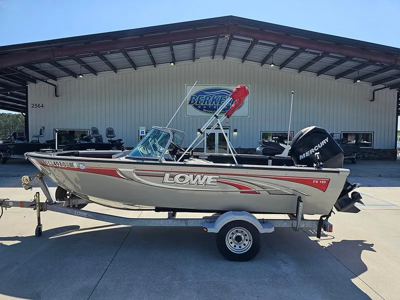 Slide: The Image of 2009 Lowe Fish & Ski FS165 boat on trailer, parked outside dealership. - 0