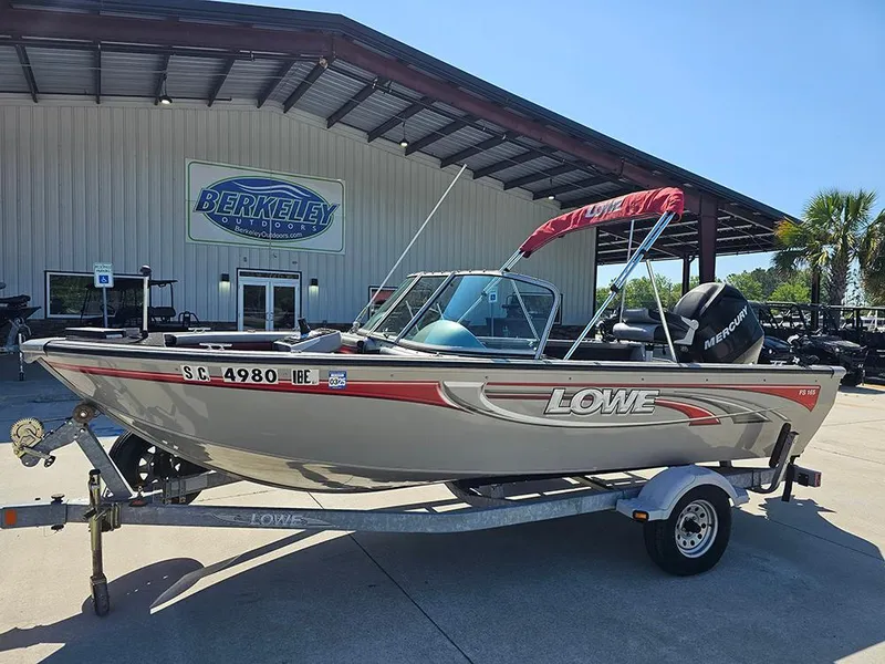 Slide: The Image of 2009 Lowe Fish & Ski FS165 boat on trailer, parked outside Berkeley building. - 1