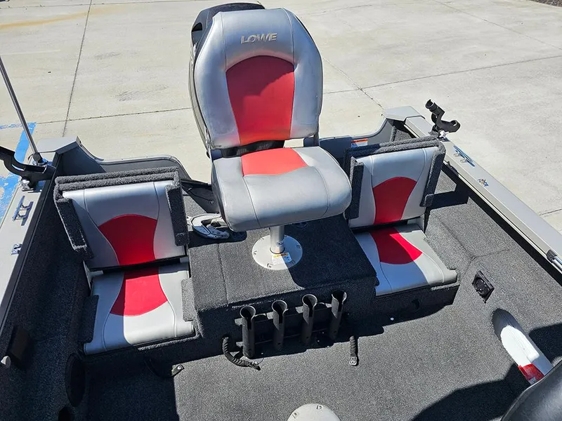 Slide: The Image of 2009 Lowe Fish & Ski FS165 boat interior with red and gray seating and rod holders. - 10