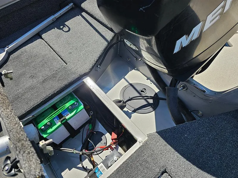 Slide: The Image of 2009 Lowe Fish & Ski FS165 boat interior with battery and motor components. - 11