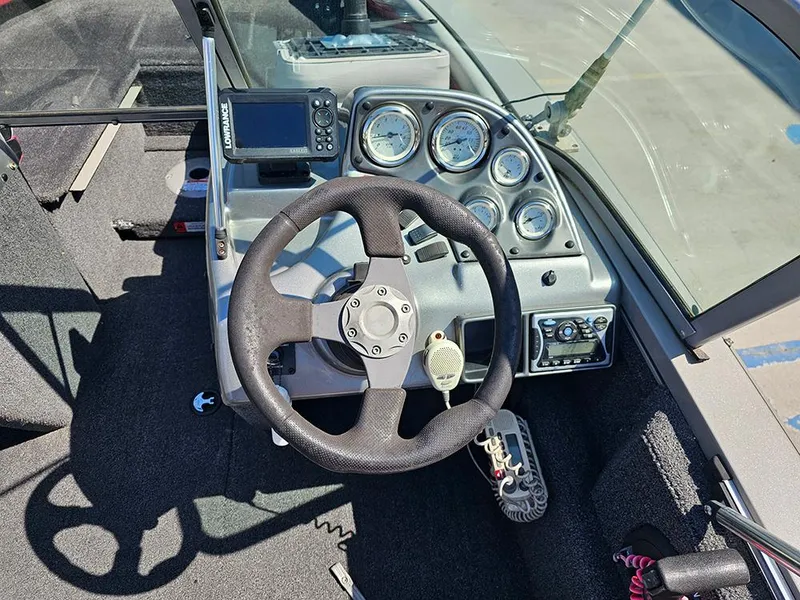 Slide: The Image of 2009 Lowe Fish & Ski FS165 dashboard with steering wheel and gauges. - 12
