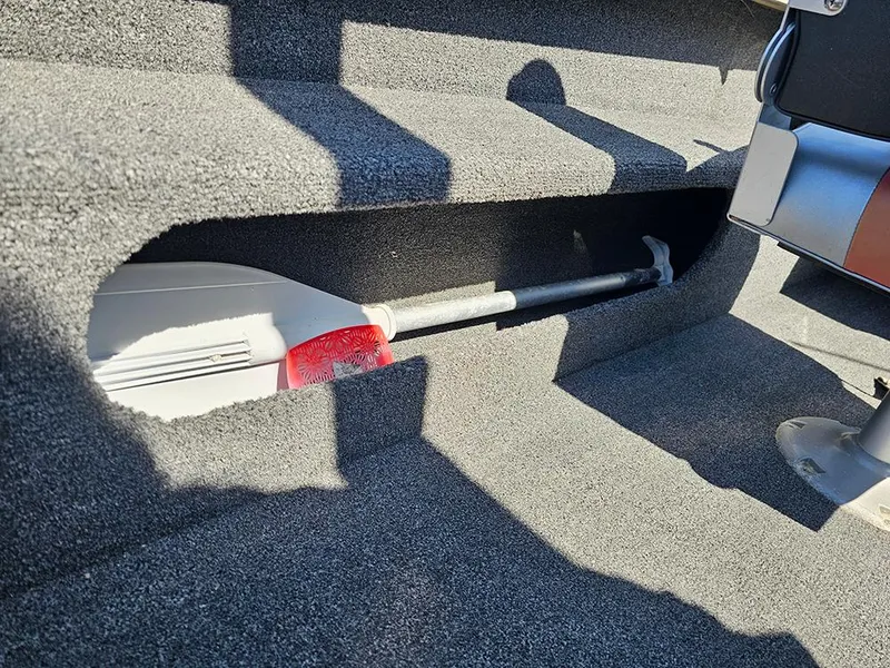 Slide: The Image of 2009 Lowe Fish & Ski FS165 boat interior with paddle storage compartment. - 20