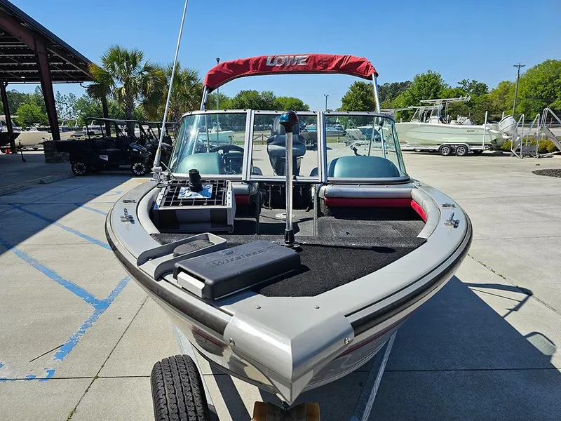 Slide: The Image of 2009 Lowe Fish & Ski FS165 boat with red canopy, parked outdoors. - 3