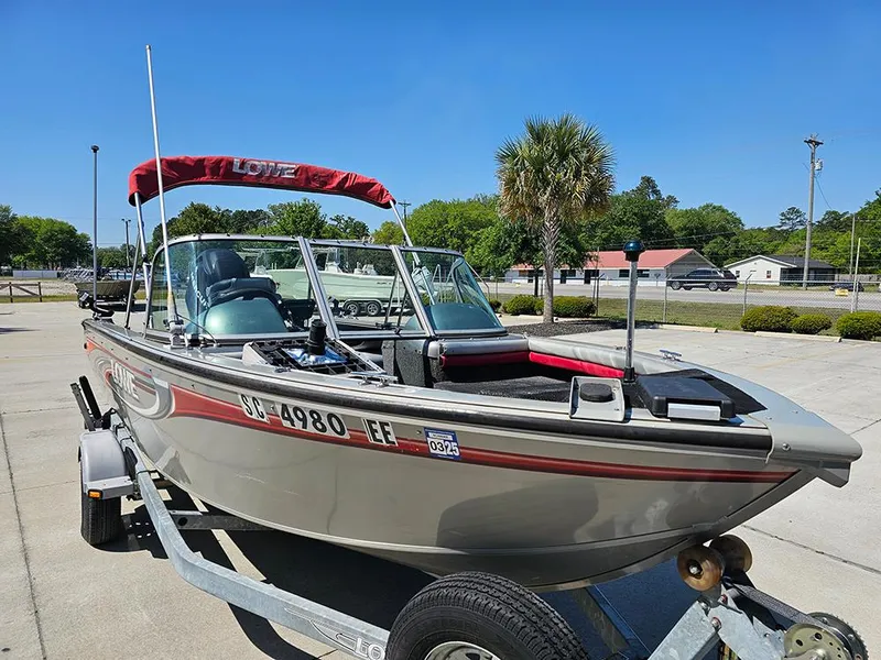 Slide: The Image of 2009 Lowe Fish & Ski FS165 boat on trailer, red canopy, parked outdoors. - 4