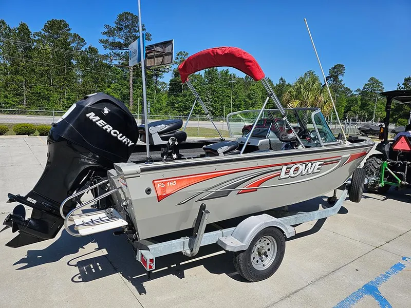 Slide: The Image of 2009 Lowe Fish & Ski FS165 boat with Mercury engine on trailer, parked outdoors. - 6