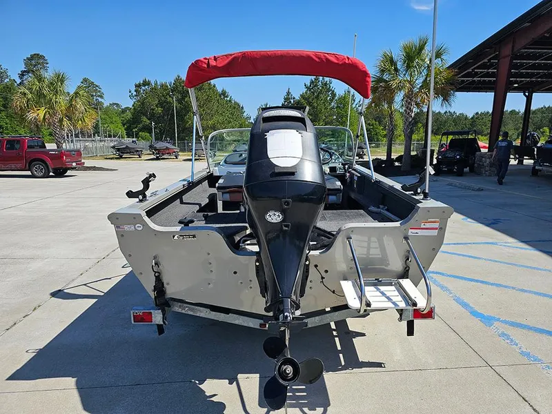 Slide: The Image of 2009 Lowe Fish & Ski FS165 boat with red canopy, parked outdoors. - 7