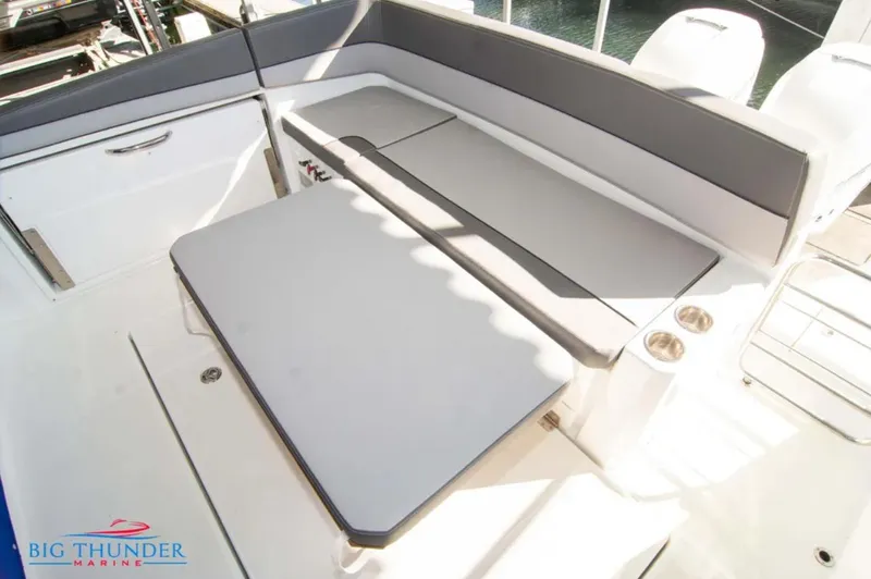 Slide: The Image of 2020 Jeanneau Leader 10.5 boat interior with seating and table, Big Thunder Marine logo. - 12
