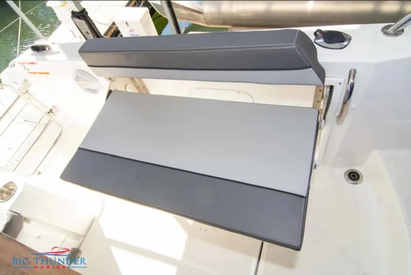 Slide: The Image of 2020 Jeanneau Leader 10.5 boat seating area with foldable bench. - 16