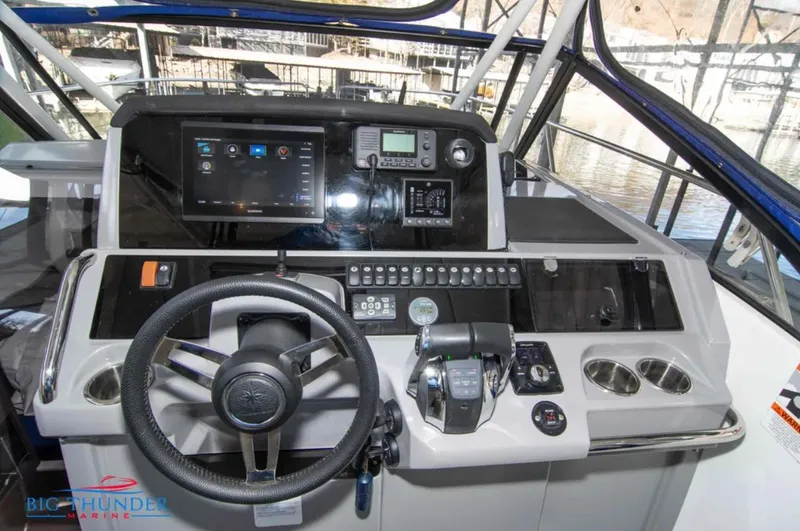 Slide: The Image of Helm of 2020 Jeanneau Leader 10.5 with modern navigation controls and steering wheel. - 22