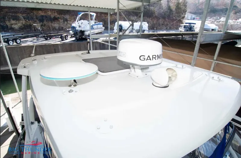 Slide: The Image of 2020 Jeanneau Leader 10.5 boat roof with Garmin radar under a covered dock. - 26