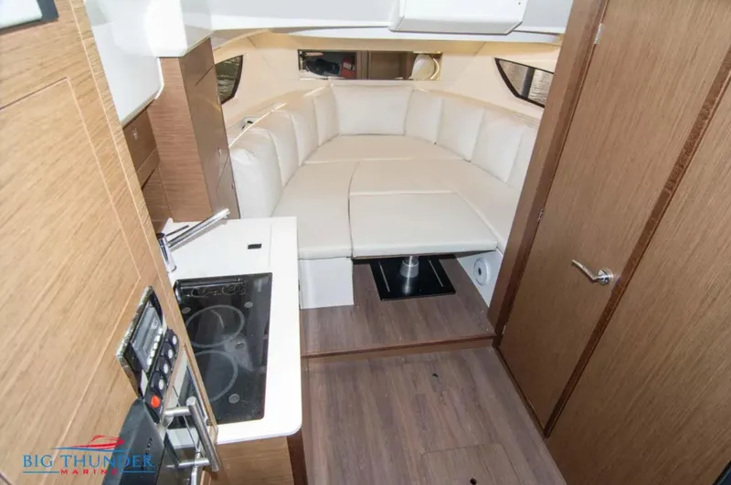 Slide: The Image of Interior of 2020 Jeanneau Leader 10.5 boat with modern kitchen and seating area. - 28