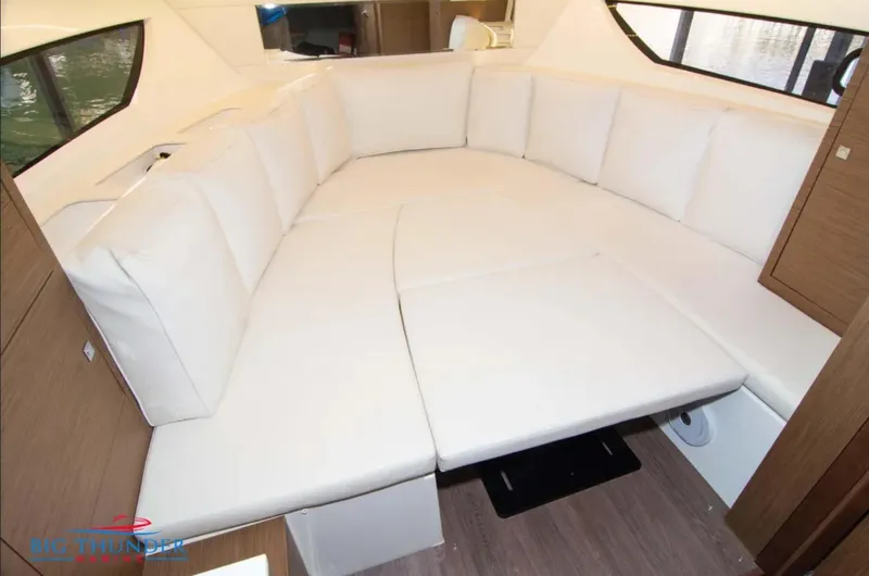 Slide: The Image of 2020 Jeanneau Leader 10.5 interior with spacious white cushioned seating area. - 31