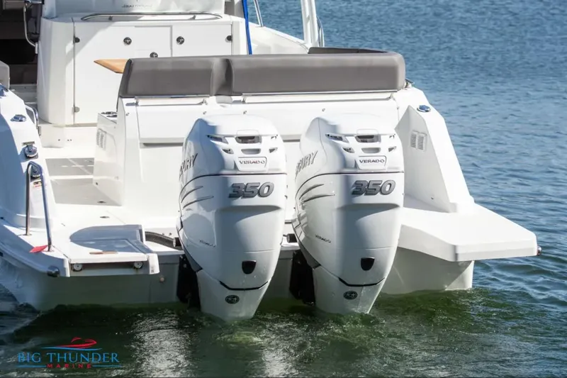 Slide: The Image of 2020 Jeanneau Leader 10.5 boat with twin Mercury 350 engines on water. - 7