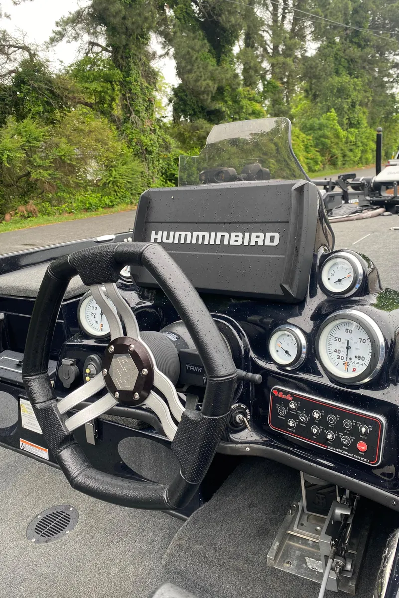 Slide: The Image of 2020 Bass Cat Eyra boat dashboard with Humminbird electronics and steering wheel. - 4