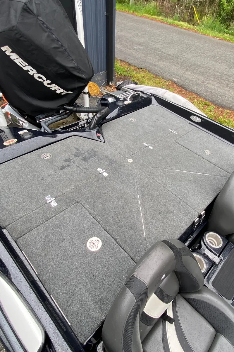 Slide: The Image of 2020 Bass Cat Eyra boat deck with Mercury engine cover, featuring storage compartments. - 6