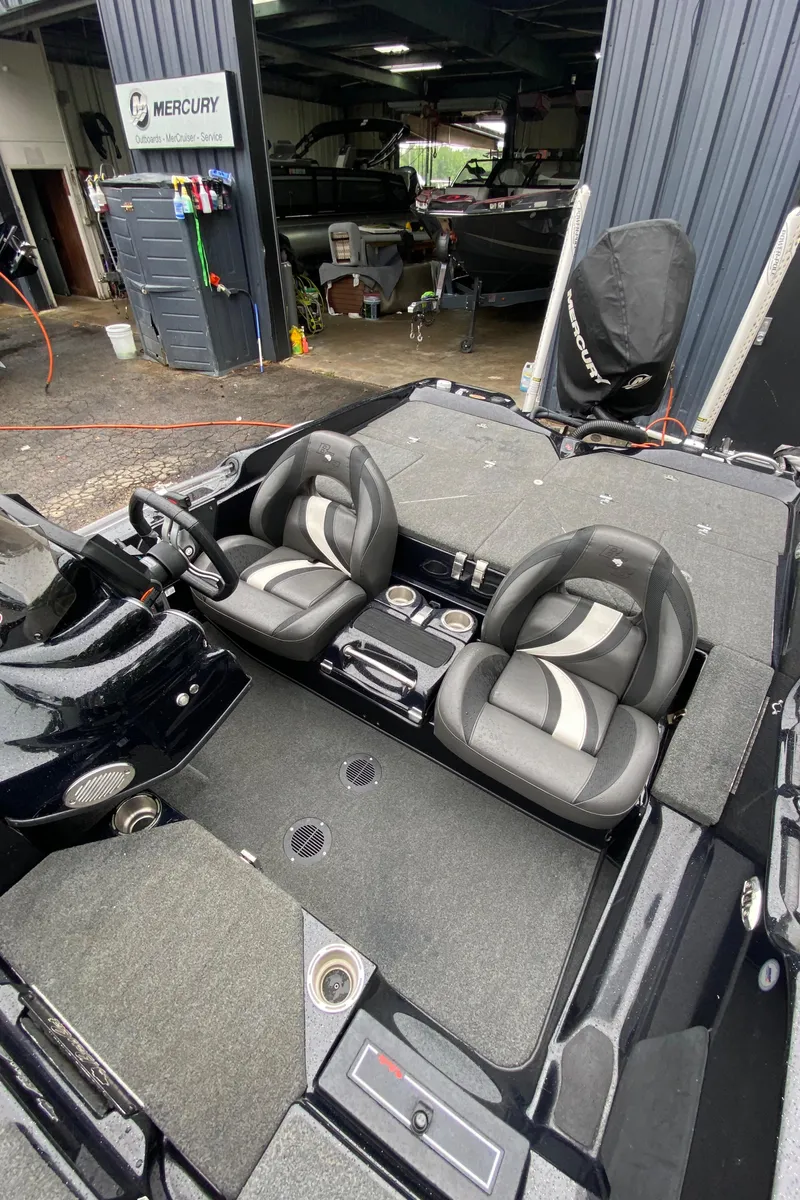 Slide: The Image of 2020 Bass Cat Eyra boat interior with dual seats and steering wheel. - 8