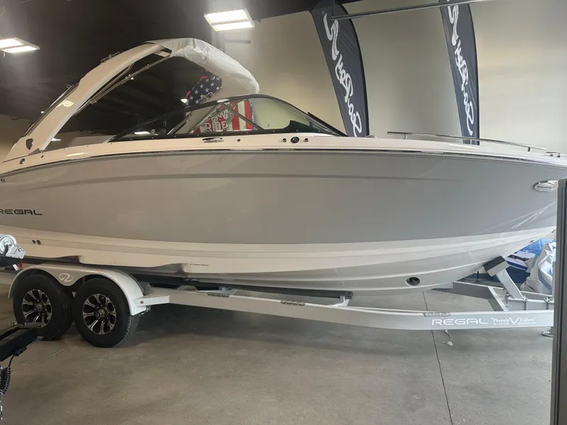 The Image of 2026 Regal LS9 boat on trailer in showroom, featuring sleek design and modern aesthetics. - 1