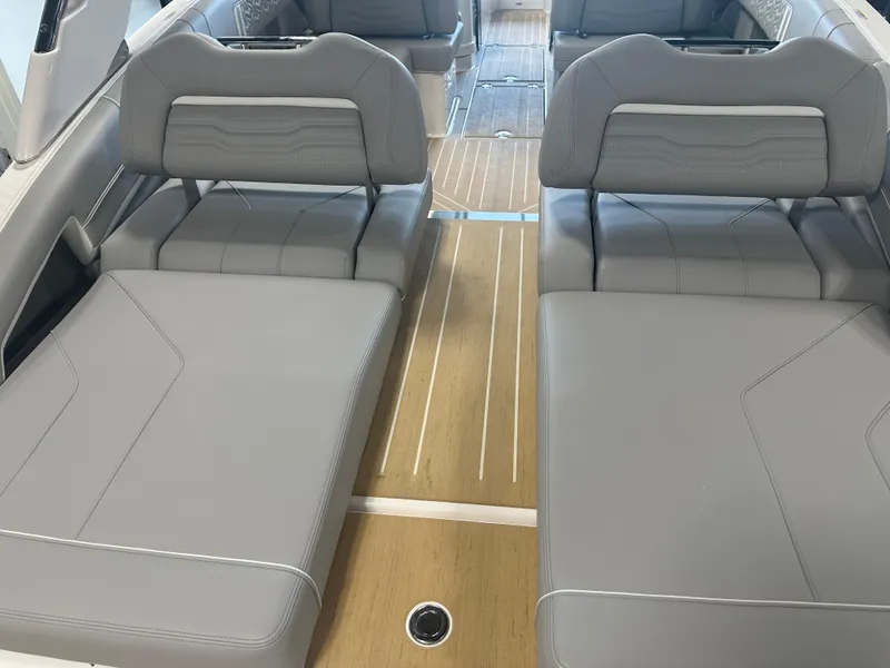 Slide: The Image of 2026 Regal LS9 boat interior with gray leather seating and wooden flooring. - 10
