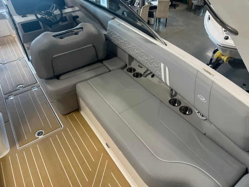Slide: The Image of 2026 Regal LS9 boat interior with gray seating, cup holders, and wood-patterned flooring. - 12