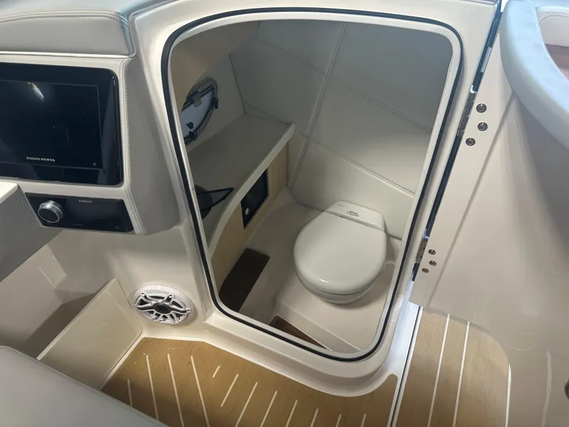 Slide: The Image of 2026 Regal LS9 boat interior with compact bathroom and modern amenities. - 14