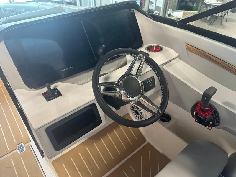 Slide: The Image of 2026 Regal LS9 boat helm with steering wheel, digital display, and control panel. - 15