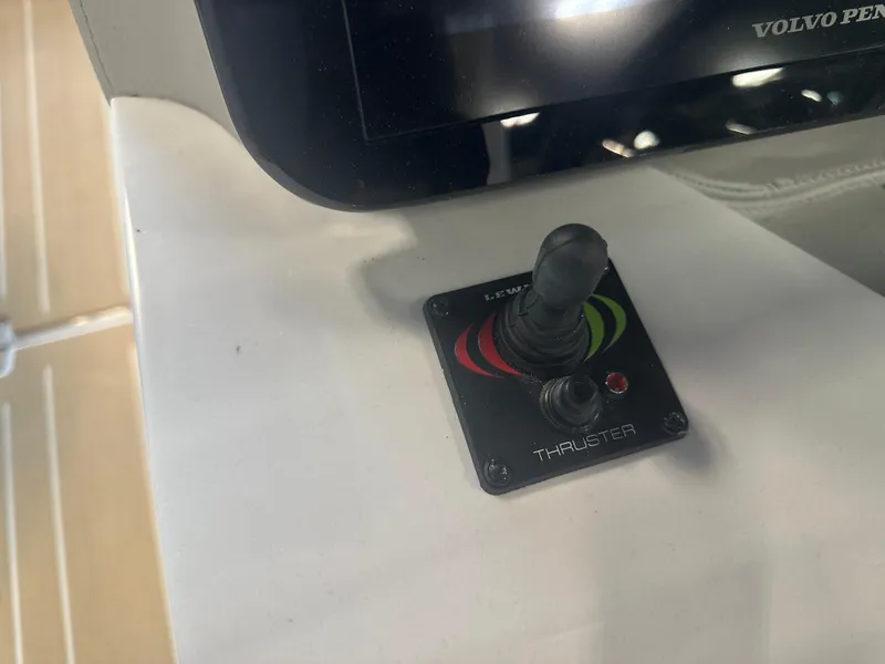 Slide: The Image of Joystick control panel on a 2026 Regal LS9 boat, featuring a thruster system. - 16